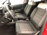 the interior of a small car with two seats and a steering wheel