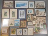 a lot of framed pictures on the wall of a room