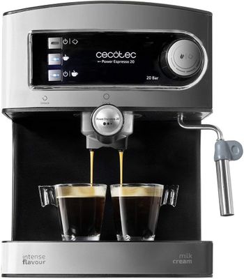 a close up of two cups of coffee being poured into a coffee machine