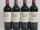 three bottles of red wine sitting next to each other on a table