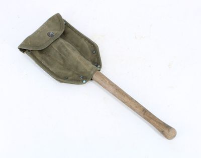 an old shovel with a wooden handle on a white surface