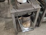 a bucket sitting on top of a table next to a bucket of food
