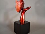 statue of a woman holding a bird in her hand on a black base