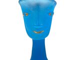 a blue glass vase with a face on it