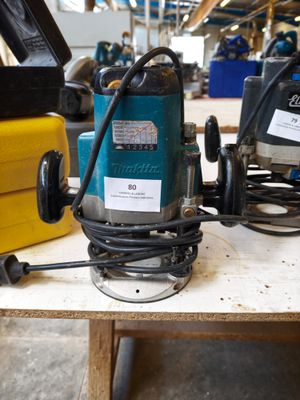 two electric tools on a table in a workshop