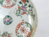 a white plate with a design on it on a stand