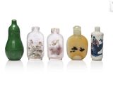 several different colored glass bottles are lined up on a white surface
