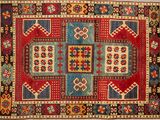 a red, blue, and yellow rug with geometric design