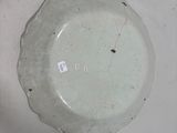 a white plate that has a small hole in it