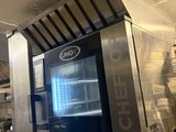 a large oven in the middle of a commercial kitchen