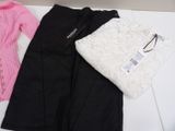 two pairs of black pants, a pink sweater and a white sweater