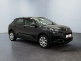 a black citrole is parked in a large room