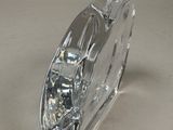 a clear glass vase with a silver handle on a table