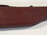 leather case for a gun on a white surface