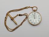 an image of a gold pocket watch with a chain around it
