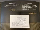 a book with a handwritten letter and a picture of a man on it