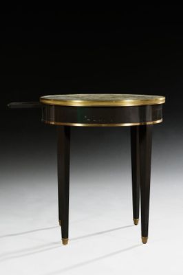 a black and gold console table with a glass top