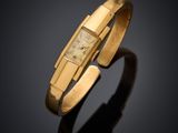 an 18k yellow gold bracelet with a square face
