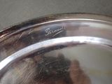 a close up of a silver plate with writing on it