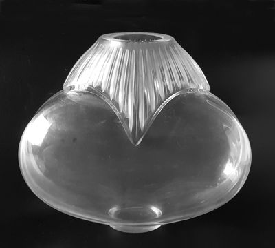 black and white photograph of a clear glass vase on a black background