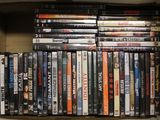 a lot of dvds in a box on the shelf