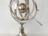 an image of a metal object on a stand on a white surface