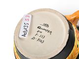 a close up of a coffee cup with a tag on it