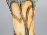 a close up of a vase on a table