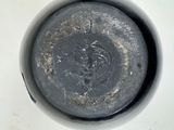 a close up view of a dirty pot with a lid