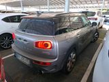 a silver mini cooper parked in a parking lot