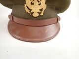 a green hat with a gold eagle on it