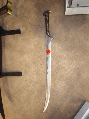 a knife that is laying on the floor next to a clock