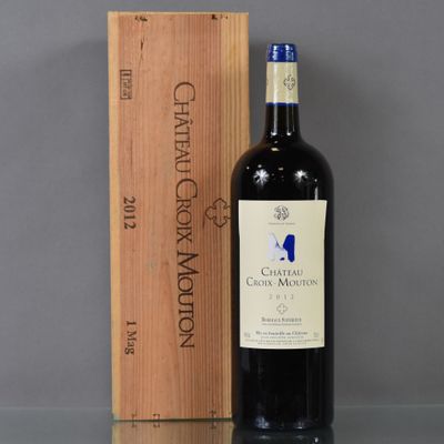 a bottle of wine sitting next to a wooden box