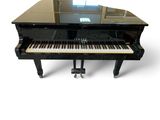 a black piano sitting on top of a black table