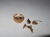 a gold ring and a pair of earrings on a table