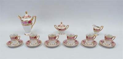 a group of pink and white porcelain tea and coffee cups and saucers