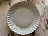a white plate that is sitting on a marble table