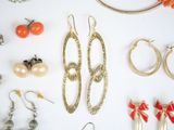 many different types of jewelry on a white surface