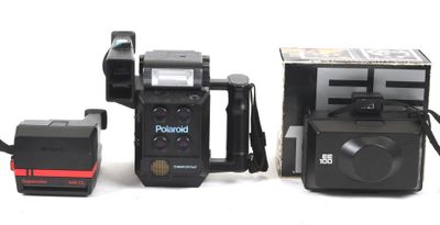 a polaroid camera sitting next to an old polaroid camera