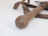 a pair of old hammers sitting on a white surface