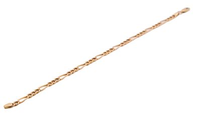 a close up of a gold chain bracelet with a heart on it