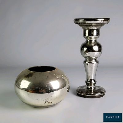 two silver vases sitting next to each other on a table