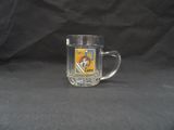 a glass mug that has a picture of a man on it