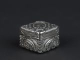 an antique silver box on a black background with a black background