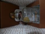a glass jar with a gold coin inside of it