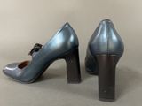a close up of a pair of blue high heels with a bow on the heel