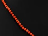 an orange coral beaded necklace on a black mannequin mannequin mannequin mannequin mannequin mannequin mannequin manne