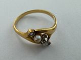 a close up of a gold ring with pearls on it