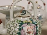 a small tea pot and a small tea pot on a table