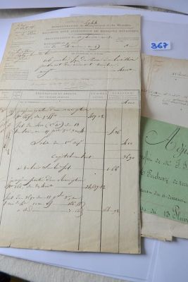 several old papers are sitting on a table next to a keyboard
